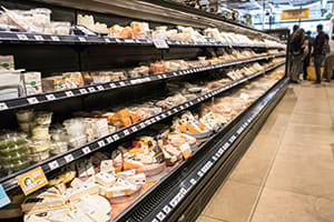 Refrigerated dairy products in a grocery store. 