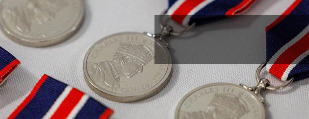 Close-up of medals with red, white, and blue ribbons.