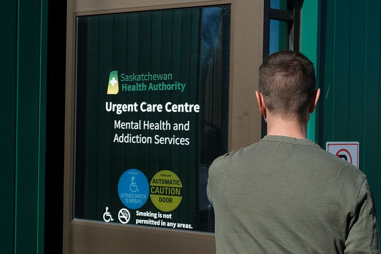 Man entering the Regina Urgent Care Centre Mental Health and Addictions Services door