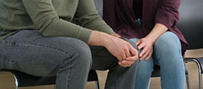 Couple holding hands in waiting room