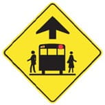 Yellow sign with school bus with red lights flashing and a figure on either side of the bus.