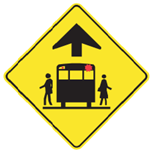 Yellow sign with school bus with red lights flashing and a figure on either side of the bus.