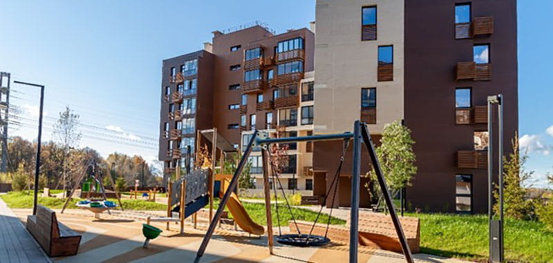 Playground equipment in front of an apartment building